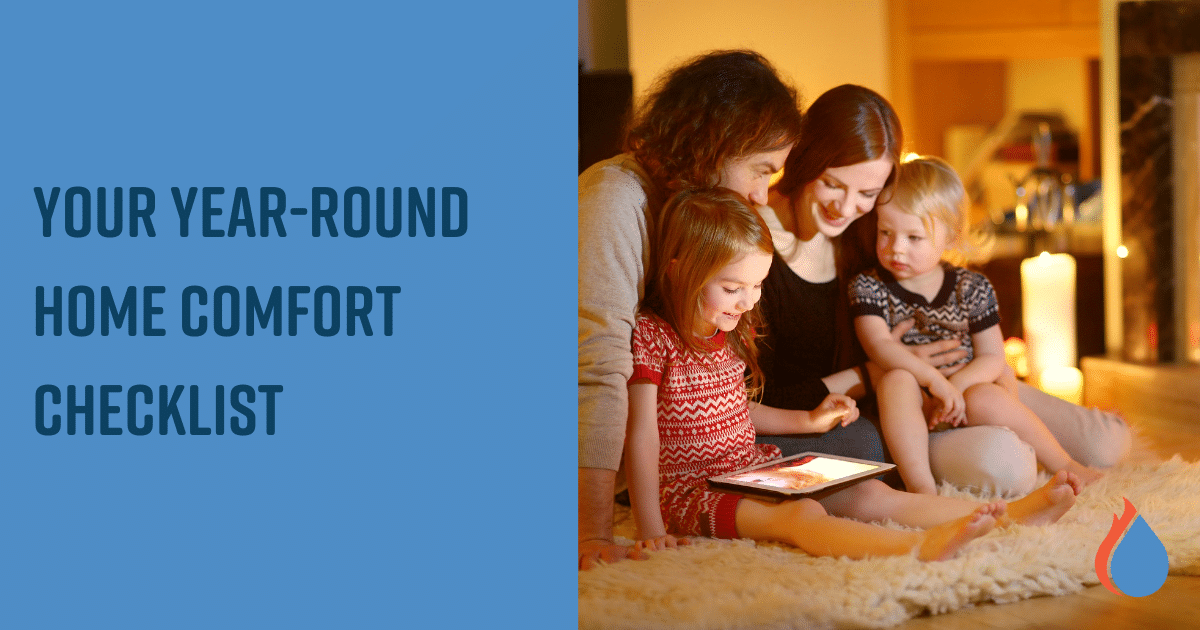 Family watching an iPad cuddled together on a rug.